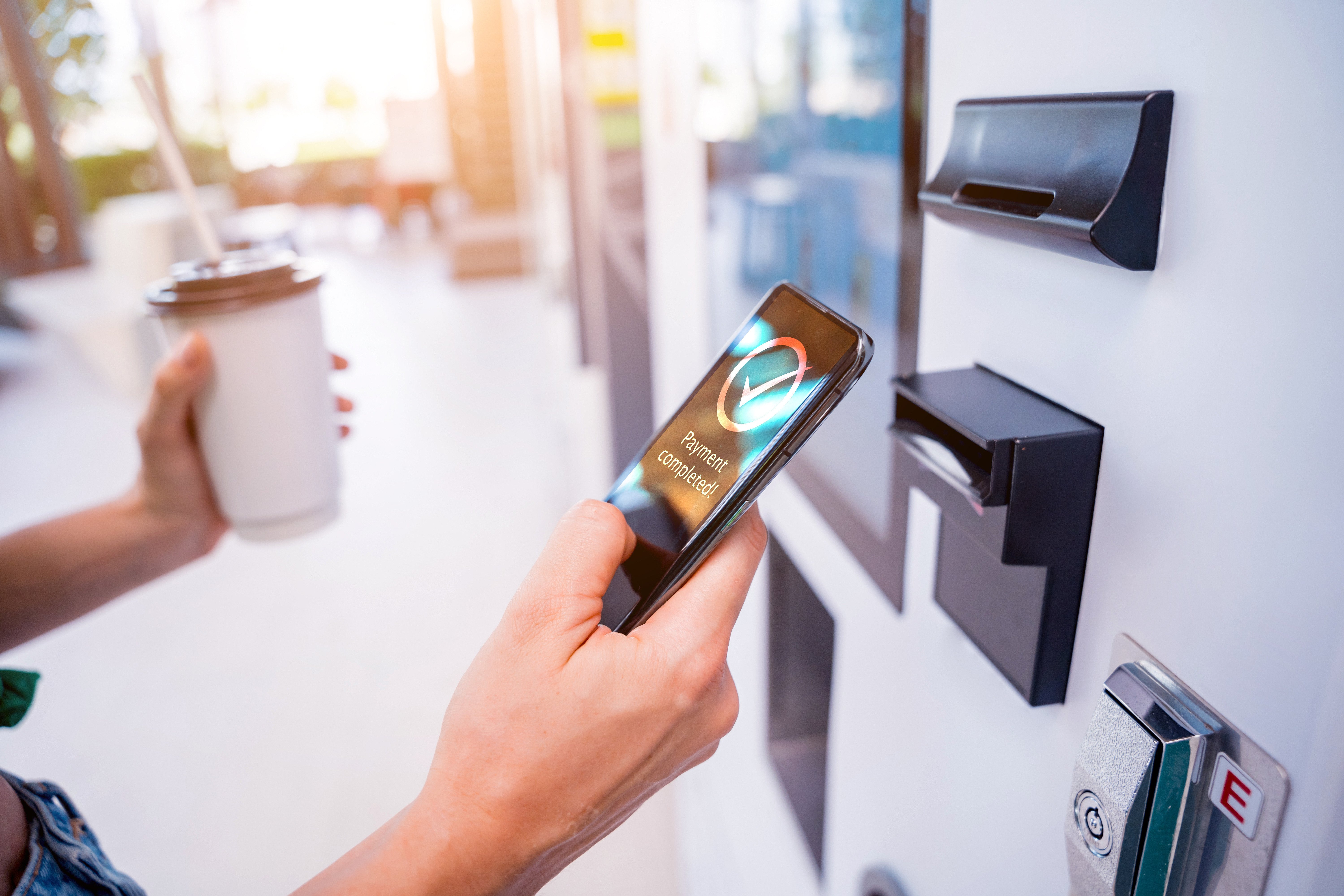 Person using tap to pay at a smart vending machine